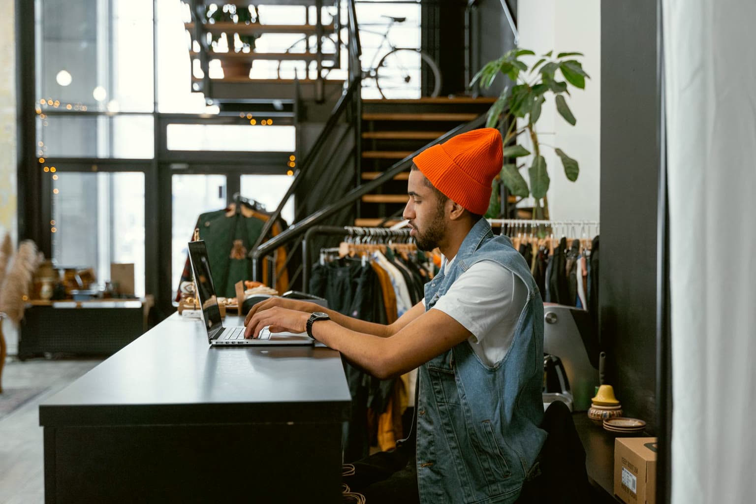 Shop owner working on a laptop at the store counter