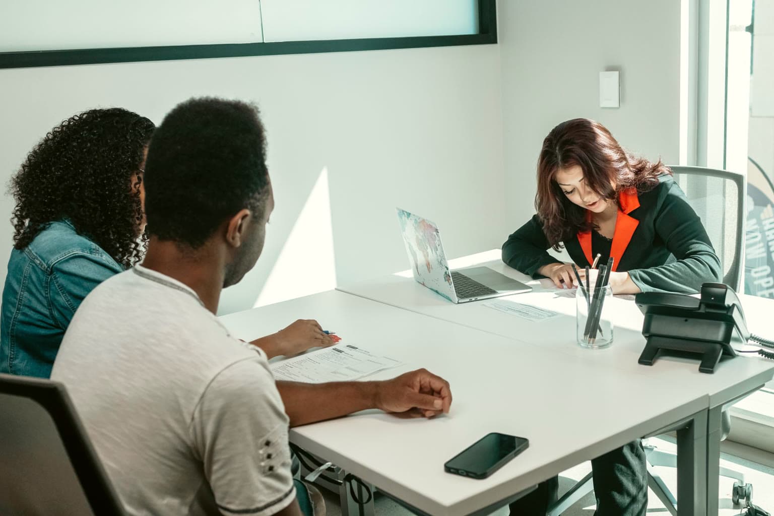 Couple meeting an adviser at a conference table